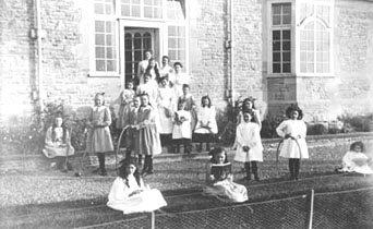 Here the girls are displaying a variety of their toys. Some are playing 'sticks and hoops' while others are holding their croquet sticks. 