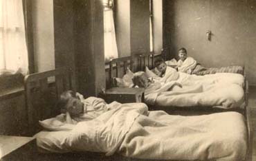 Children's homes were run to a rigid timetable to ensure that everybody was tucked up in bed at the same time. We are not certain which home this photograph is of - but it may be the Gordon Home For Boys in Croydon.