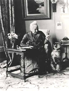 Visitors to children's homes would arrive and be entertained in the reception room. This lady with the dog is Miss Bailey, who was the wife of St Andrew's founder.